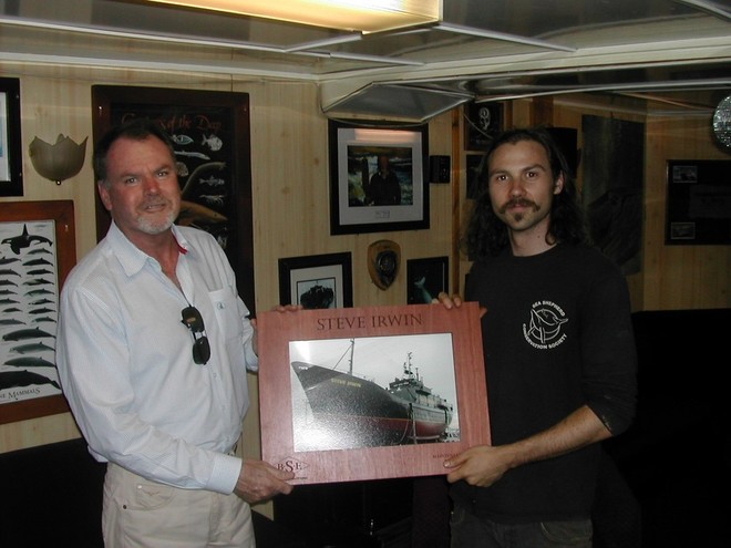 Denis Maher presents the memento of Brisbane Slipways’ work to a Ben Baldwin, representative of Sea Shepherd. © MIAA